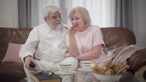 Stock Video Old Couple Watching A Tv Comedy Show Live Wallpaper