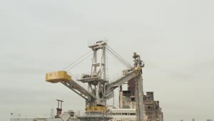 Stock Video Old Crane Loading Ships On A Coast Live Wallpaper