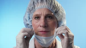 Stock Video Old Female Doctor Puts On The Mask Live Wallpaper