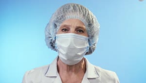Stock Video Old Female Doctor Wearing Surgery Clothes And Mask Live Wallpaper
