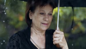 Stock Video Old Sad Woman At A Funeral While Raining Live Wallpaper