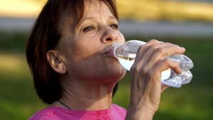 Stock Video Old Woman Drinking Water From A Bottle Live Wallpaper