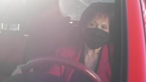 Stock Video Old Woman Wearing Mask While Driving Her Car Live Wallpaper