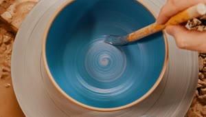 Stock Video Painting A Spinning Pot Blue Using A Brush Live Wallpaper