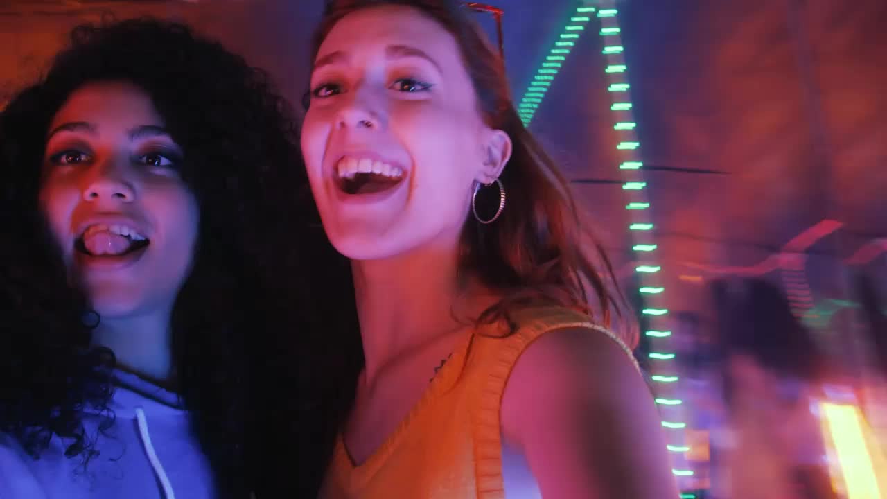 Download Stock Video Pair Of Female Friends Having Fun On A Night Out Live Wallpaper