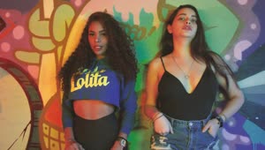 Stock Video Pair Of Girls Leaning Against A Wall With Graffiti Live Wallpaper