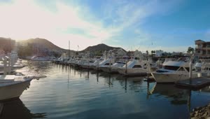 Stock Video Panorama Of A Tourist Port Full Of Boats And Sailboats Live Wallpaper