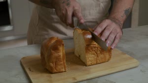 Stock Video Pastry Chef Cutting A Loaf Into Slices Live Wallpaper