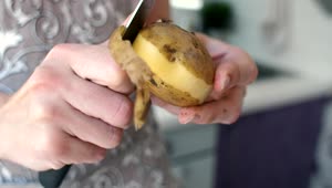 Stock Video Peeling A Potato With A Knife Live Wallpaper