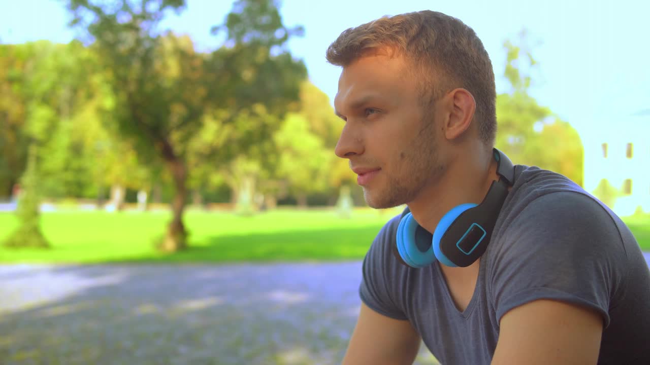 Download Stock Video Pensive Young Man Listening To Music On His Headphones Live Wallpaper