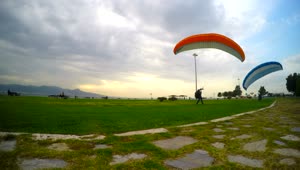 Stock Video People Practicing Parachuting On A Cloudy Day Live Wallpaper