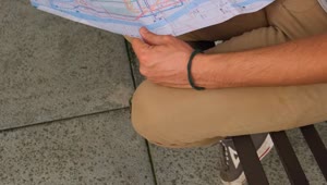 Stock Video People Sitting On The Street Reviewing A Map Together Live Wallpaper