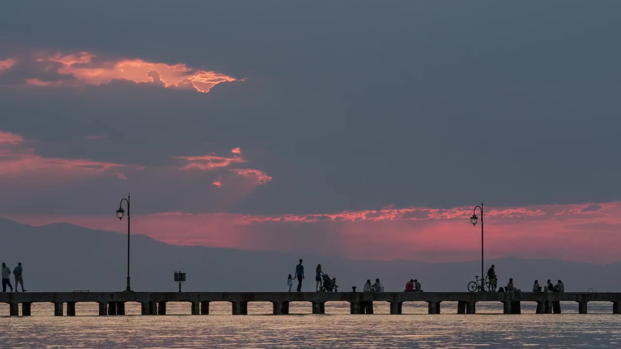 Download Stock Video People Walking Along A Pier At Night Live Wallpaper