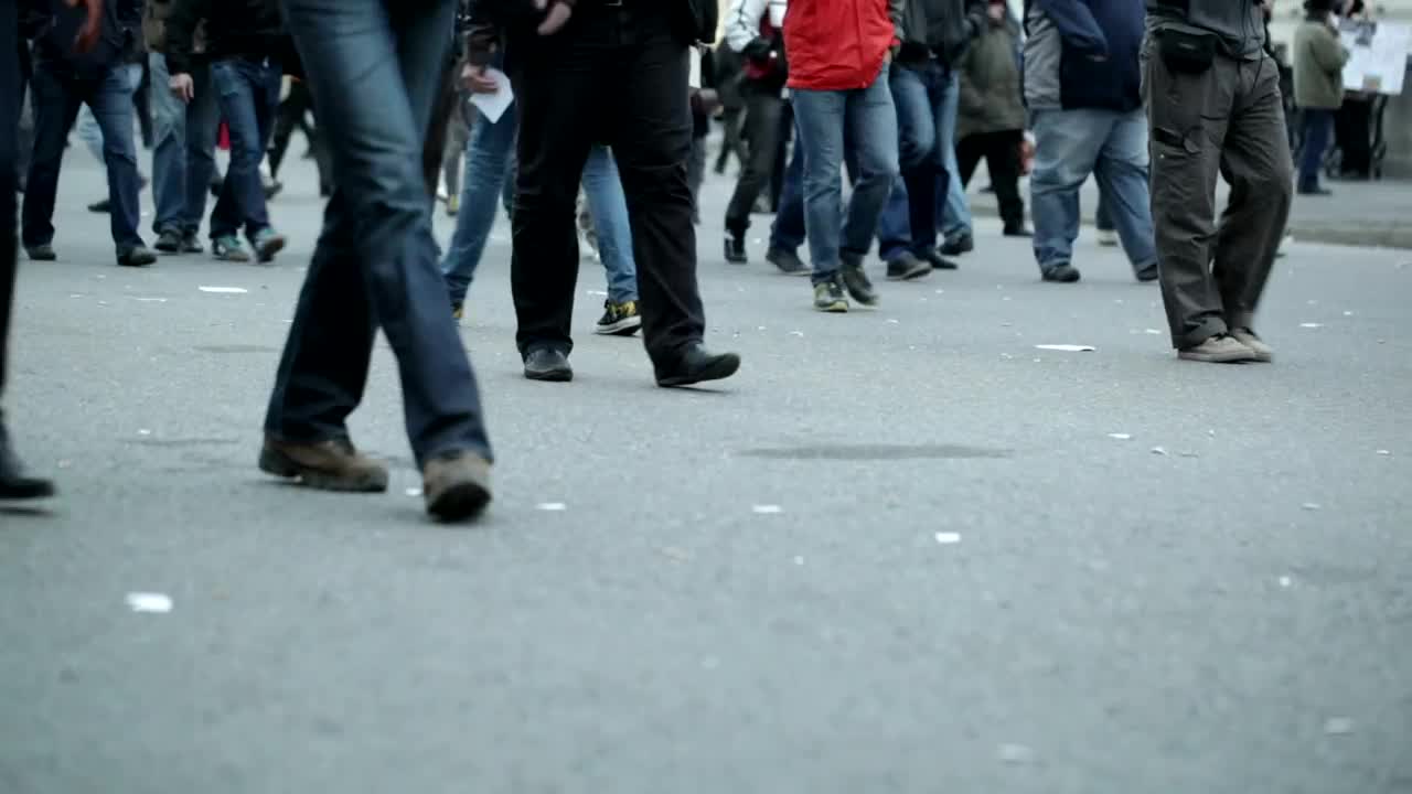 Download Stock Video People Walking Slowly Across Town Live Wallpaper
