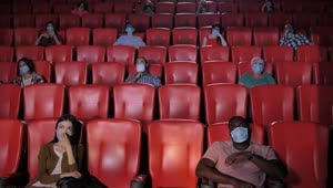 Stock Video People With Masks Watching A Movie In A Cinema Live Wallpaper