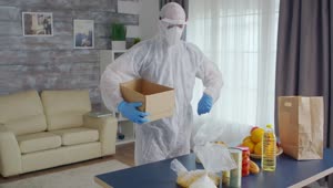 Stock Video Person In Coronavirus Quarantine Packs Food Into Box Live Wallpaper