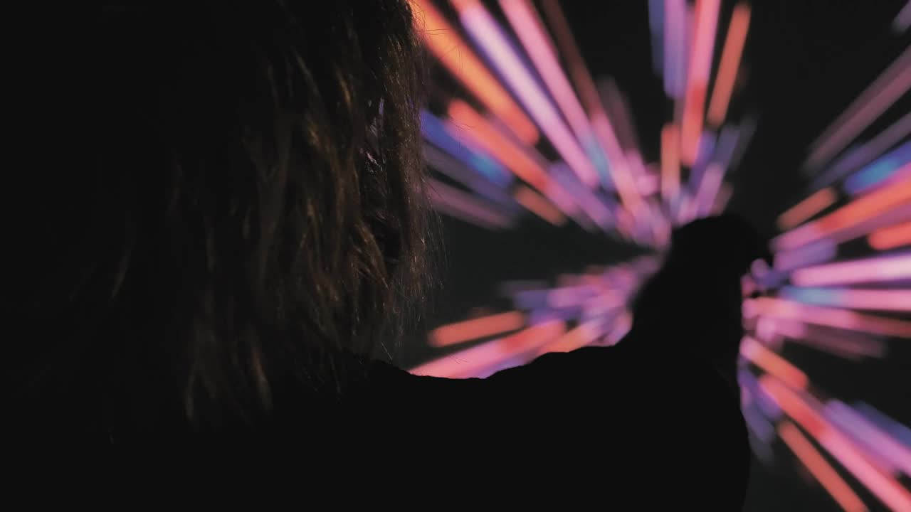 Download Stock Video Person In The Dark With A Colored Lights Background Live Wallpaper