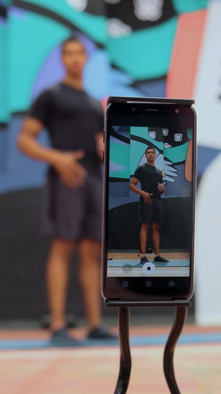 Download Stock Video Person Is Filmed Exercising With A Cell Phone Live Wallpaper