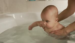 Video Stock Person Puts A Baby In The Bathtub Live Wallpaper Free