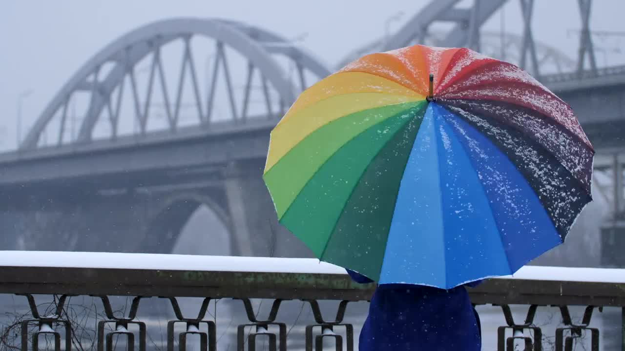 Download Video Stock Person With A Colorful Umbrella On A Snowy Day Live Wallpaper Free