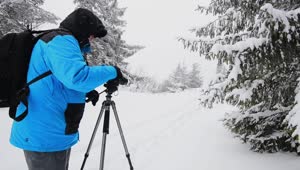 Video Stock Photographer In A Winter Forest With His Camera Live Wallpaper Free