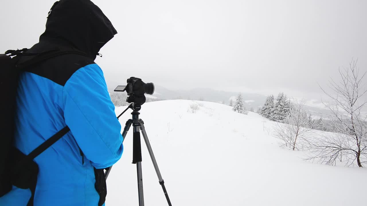 Download Video Stock Photographer Taking Photos While Snowing In The Forest Live Wallpaper Free
