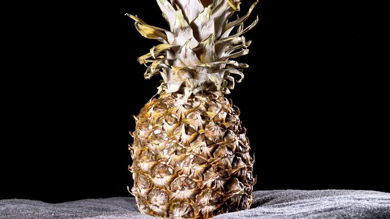 Download Video Stock Pineapple Rotating On A Black Background Live Wallpaper Free