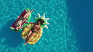 Video Stock Pool With Two Girls Lying On Floats Live Wallpaper Free