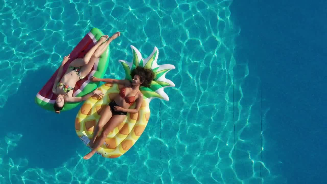 Download Video Stock Pool With Two Girls Lying On Floats Live Wallpaper Free