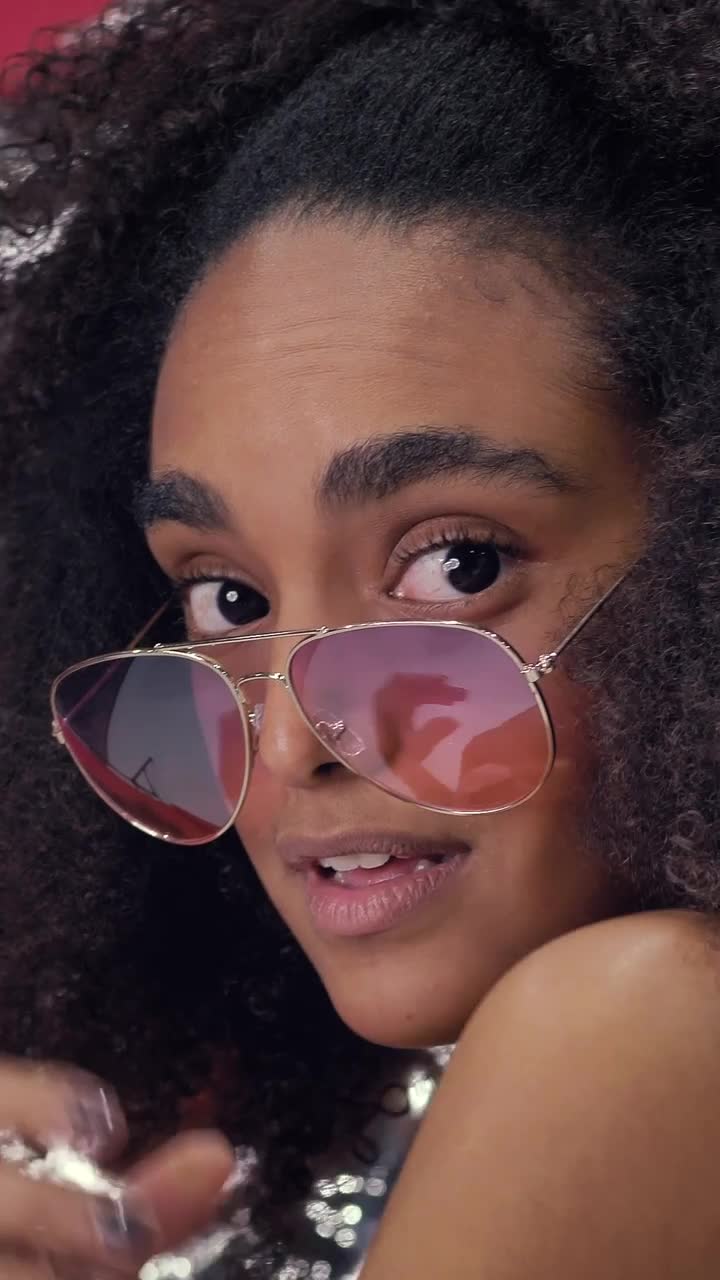 Download Video Stock Portrait Of A Captivating Young Woman Wearing Sunglasses Live Wallpaper Free