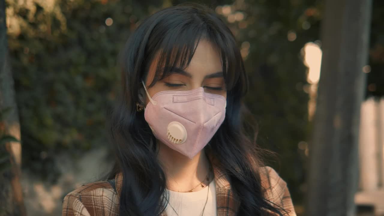 Download Video Stock Portrait Of A Woman With Face Mask In The Street Live Wallpaper Free