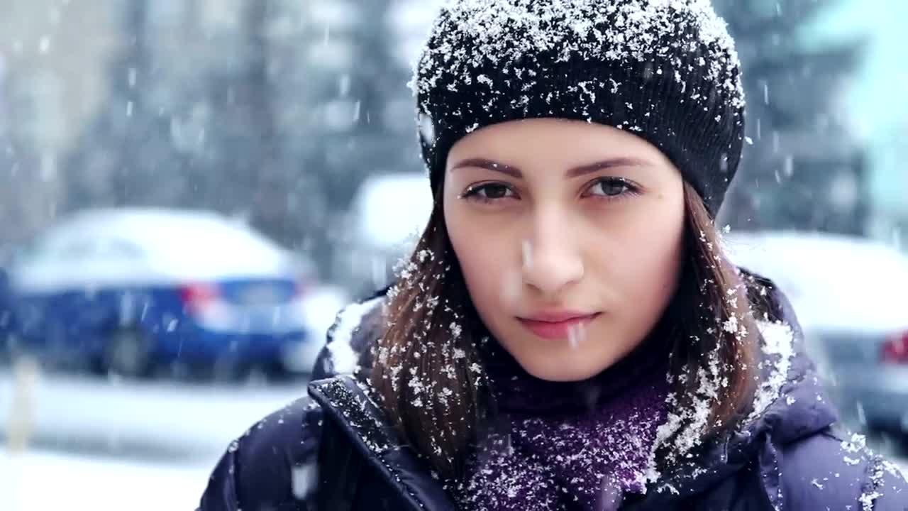 Download Video Stock Portrait Of Woman Outdoors While Snowing Live Wallpaper Free