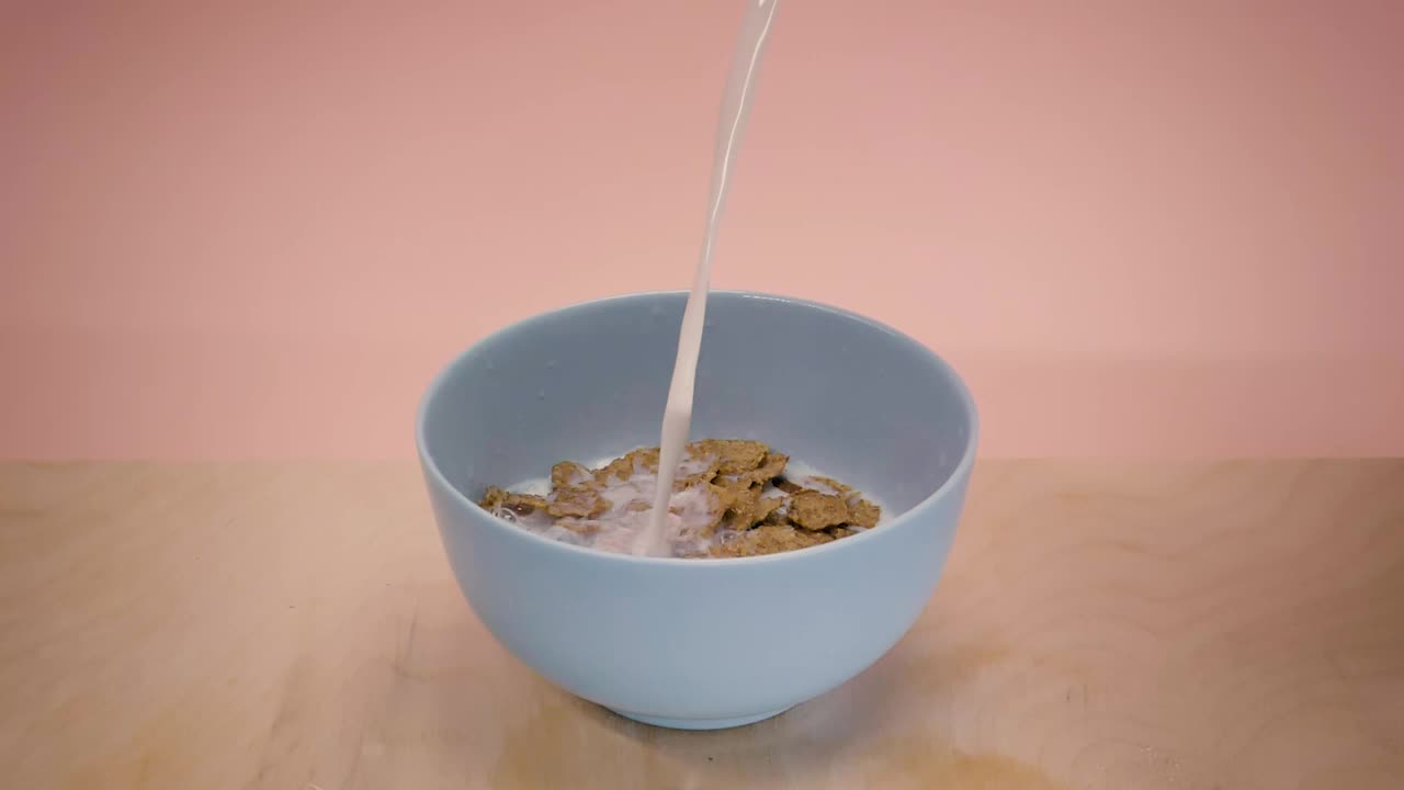 Download Video Stock Pouring Milk Into A Bowl With Chocolate Flavored Cereal Live Wallpaper Free