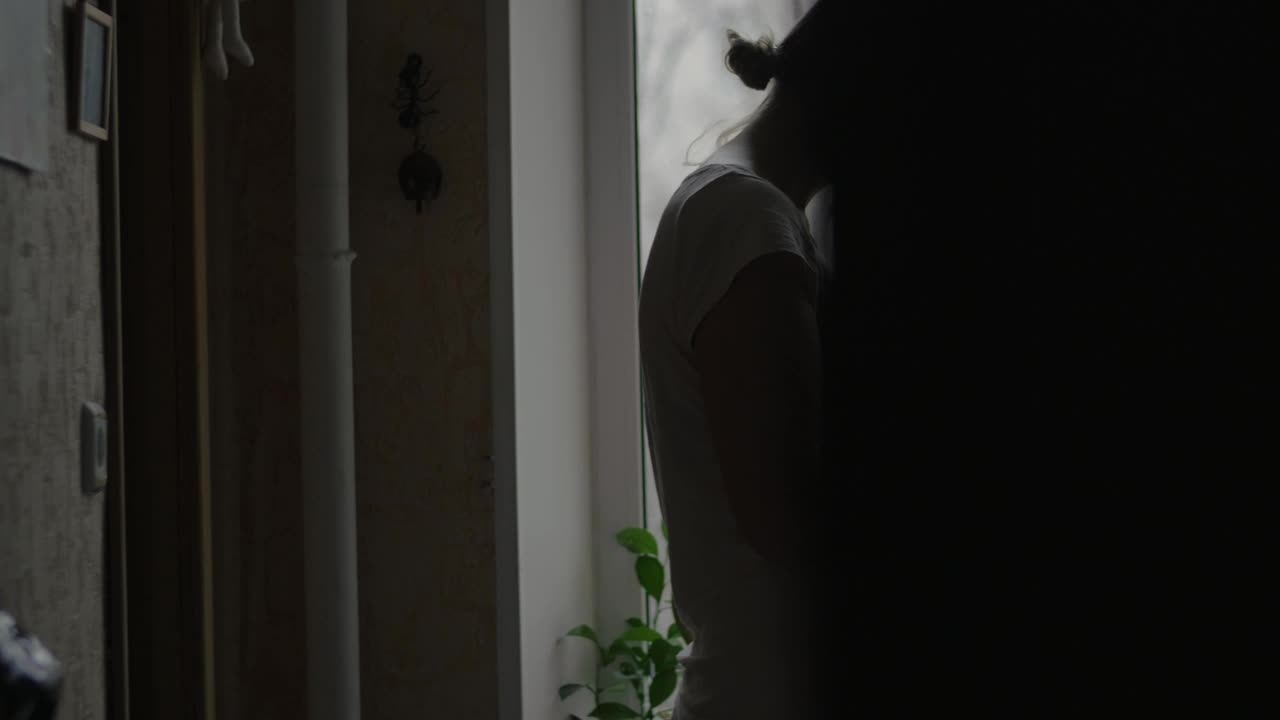 Download Video Stock Pregnant Woman Standing By A Window Live Wallpaper Free