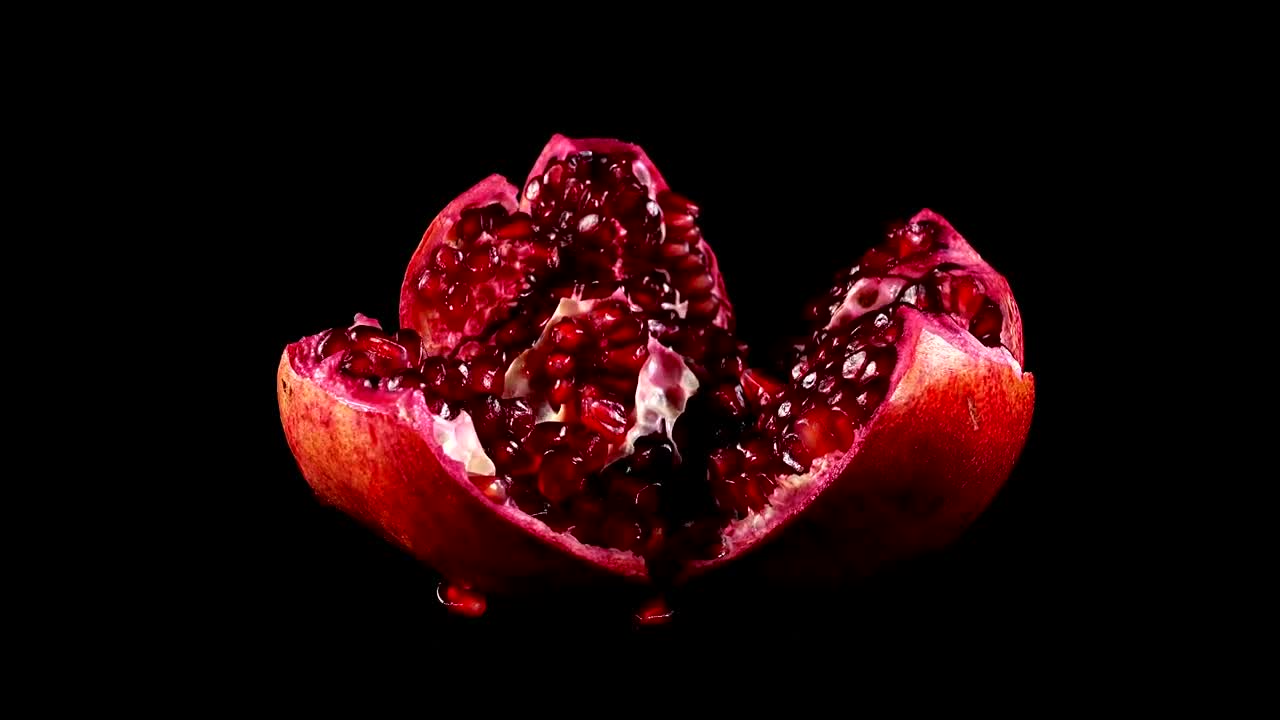 Download Video Stock Presentation Of A Pomegranate On A Black Background Live Wallpaper Free