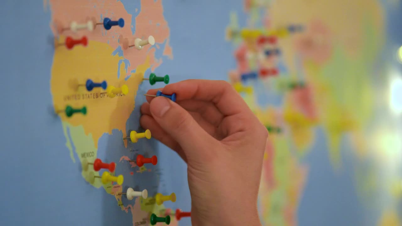 Download Video Stock Putting Thumbtacks On A World Map Board Live Wallpaper Free