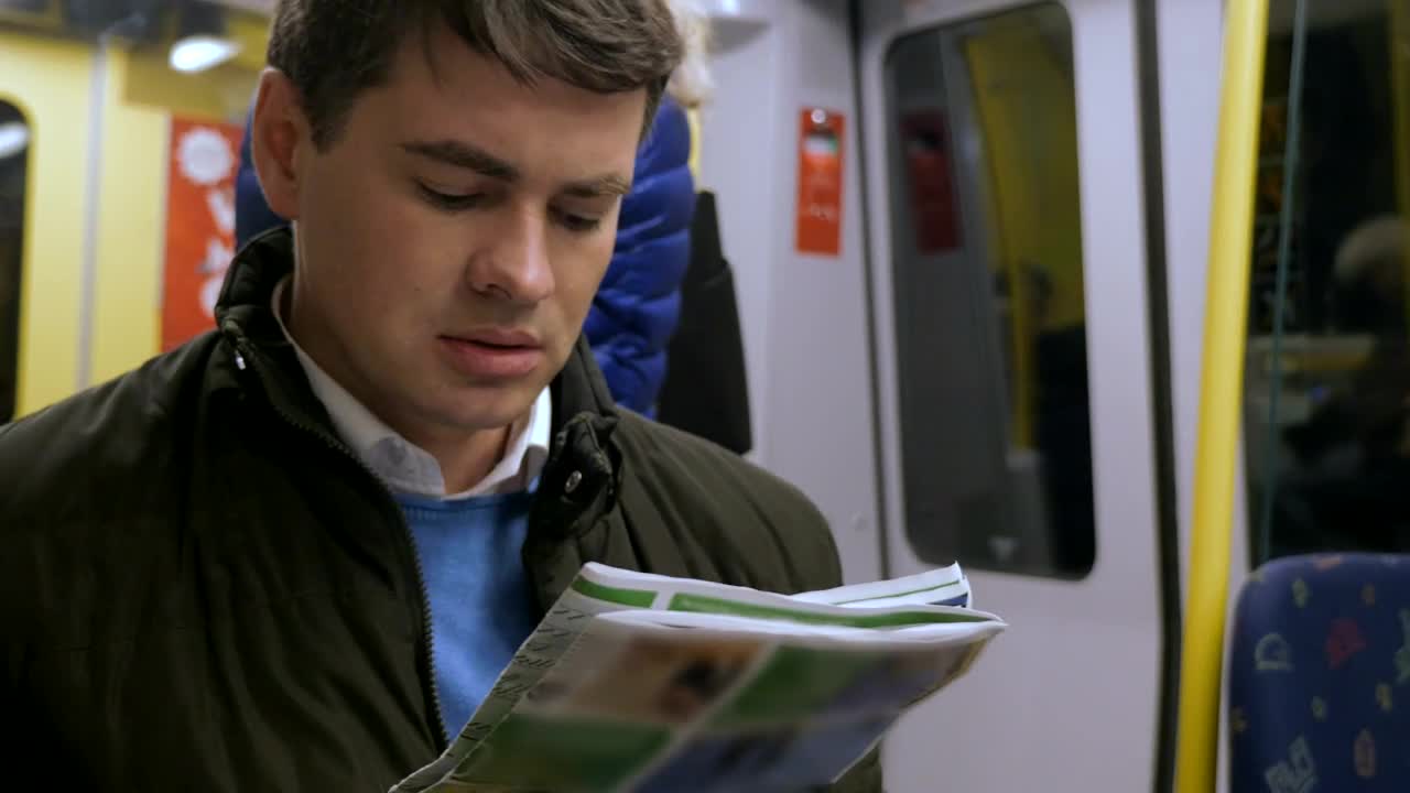 Download Video Stock Reading A Newspaper On The Train Live Wallpaper Free