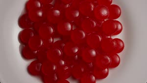 Video Stock Red Candies Slowly Spinning On A Plate Live Wallpaper Free