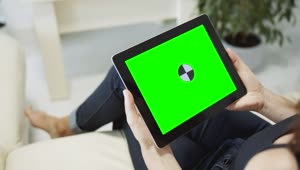 Free Stock Video Sitting On Sofa Browsing Web On Chroma Key Tablet Live Wallpaper