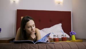 Free Stock Video Relaxed Woman Reading A Book Lying On Her Bed Live Wallpaper
