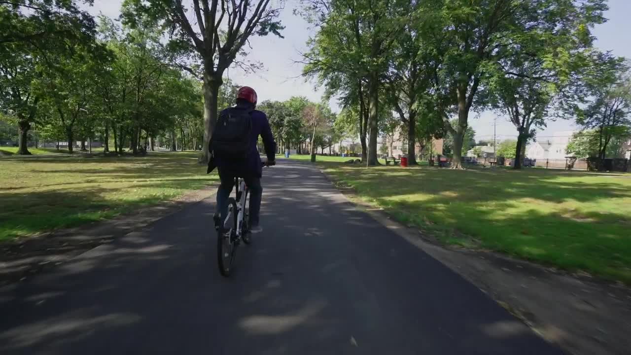 Download Free Stock Video Riding A Bike Through A City Park Live Wallpaper