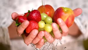 Download Free Stock Video Rinsing Strawberries Apples And Grapes Holding Hands Live Wallpaper