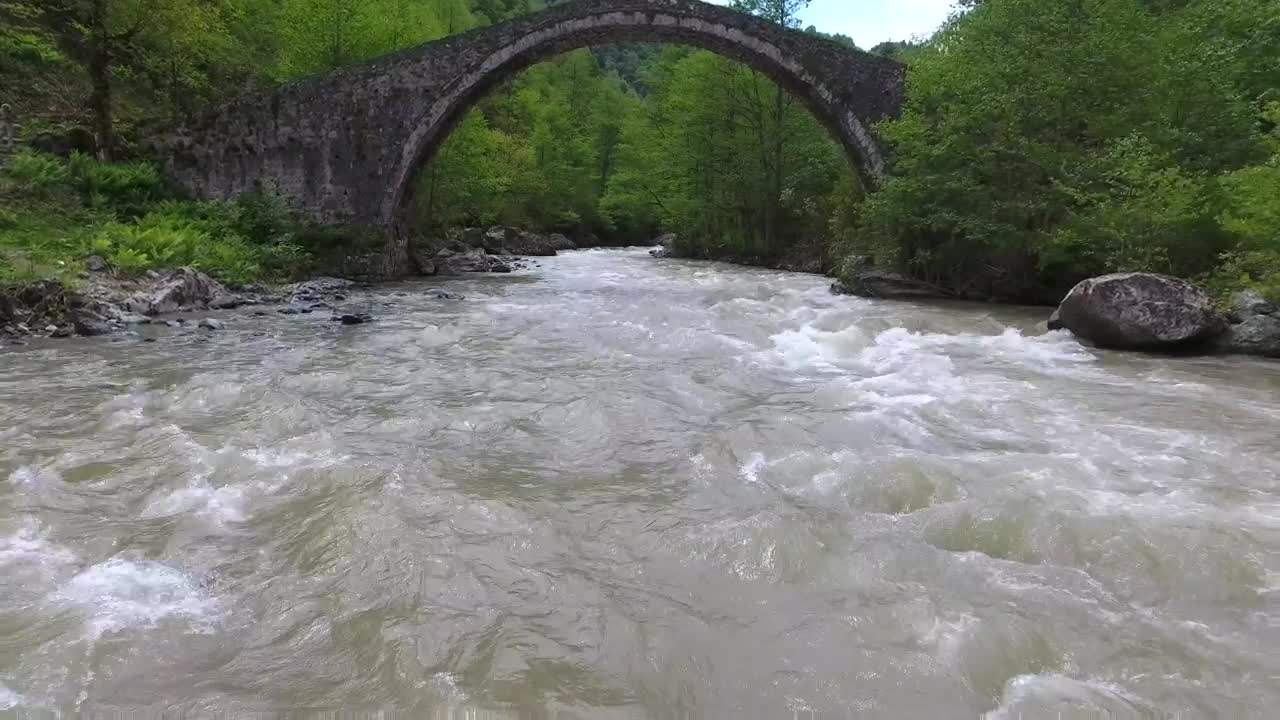 Download Free Stock Video River Flowing Under An Old Stone Bridge With A Woman Live Wallpaper
