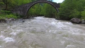 Free Stock Video River Flowing Under An Old Stone Bridge With A Woman Live Wallpaper