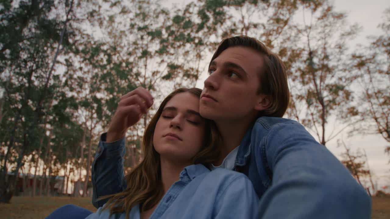 Download Free Stock Video Romantic Couple Sitting On The Grass In A Forest Live Wallpaper