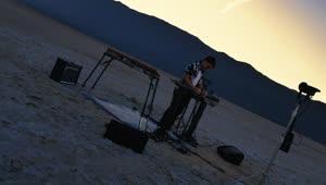 Free Stock Video Rotating Shot Of A Dj Playing In A Lonely Desert Live Wallpaper