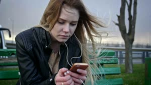 Free Stock Video Sad Girl On A Bench Looking To Her Smartphone Live Wallpaper