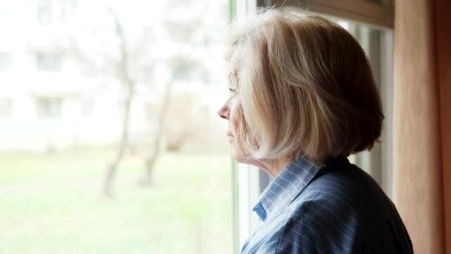Download Free Stock Video Sad Woman Looking Out Of A Large Window Live Wallpaper