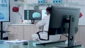 Free Stock Video Scientist Typing In Front Of Dna Models In Modern Lab Live Wallpaper