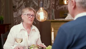 Free Stock Video Senior Woman Chats Over Romantic Dinner In Modern Restaurant Live Wallpaper